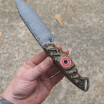 80crv2, Bow Drill with layered Canvas Micarta and Red G10 liners fly around.