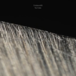 Microscopic view of a knife dulling in real time against cardboard [credit: OUTDOORS55 on Youtube]