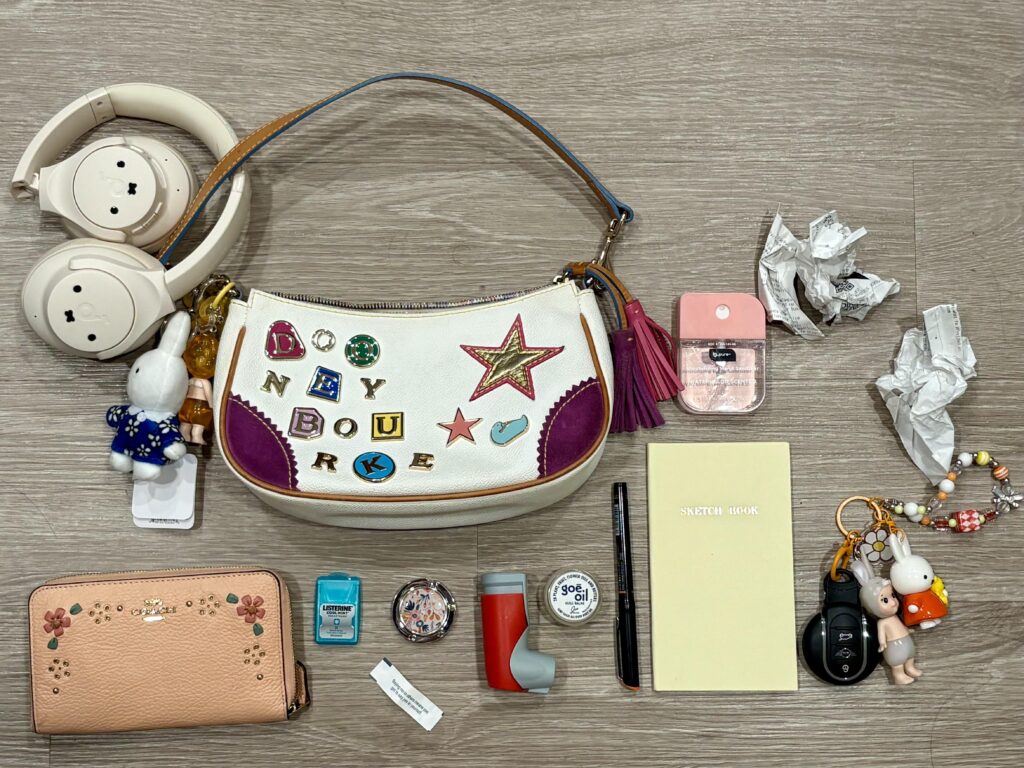 kinda cheating since i hang my headphones on the strap. you can also fit a lot when you shove your receipts in any crevice lol