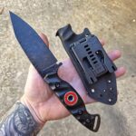 80crv2, Apocalyptic finish, Bow Drill Bushcraft knife, Sandblasted Black G10 with Royal purple liners. Stainless bow drill divot bearing.