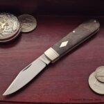 Clip point in O1 with Walnut covers.