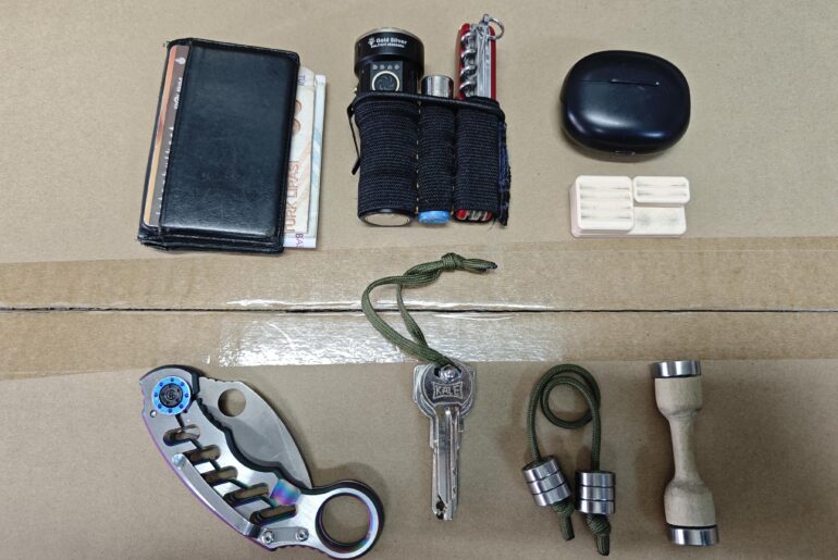 Inside her wallet there is a comb and a multi-purpose metal business card holder.