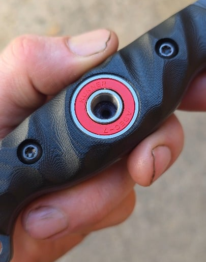 80crv2, Apocalyptic finish, Bow Drill Bushcraft knife, Sandblasted Black G10 with Royal purple liners. Stainless bow drill divot bearing.