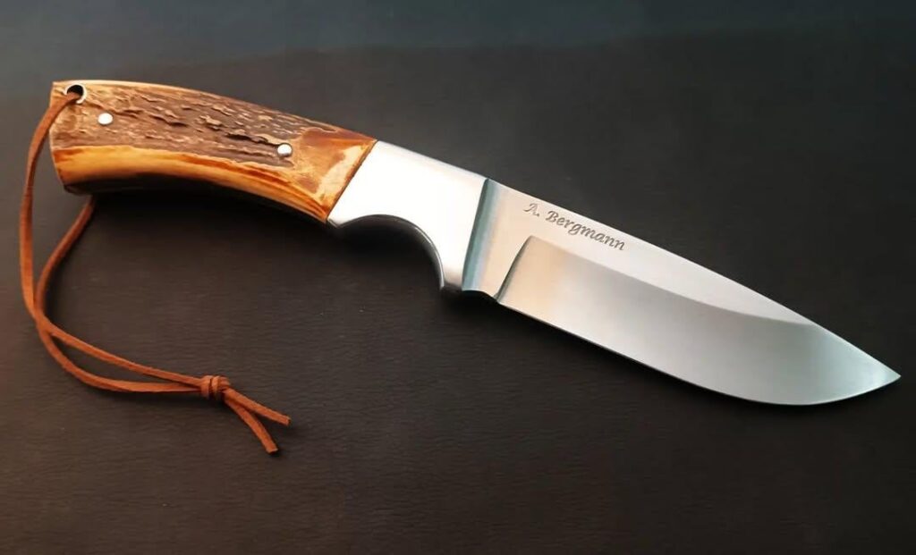 Hunting knife, forged from carbon steel with an integral bolster.