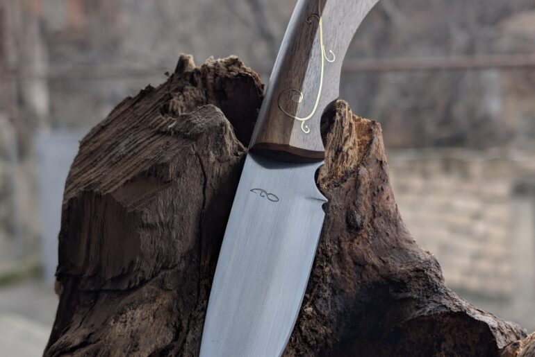 My latest one. Made of 9KhF, Soviet chromium-vanadium high carbon steel, Handle of Walnut with brass inlay and pins. 58-59 HRC. DM me if interested