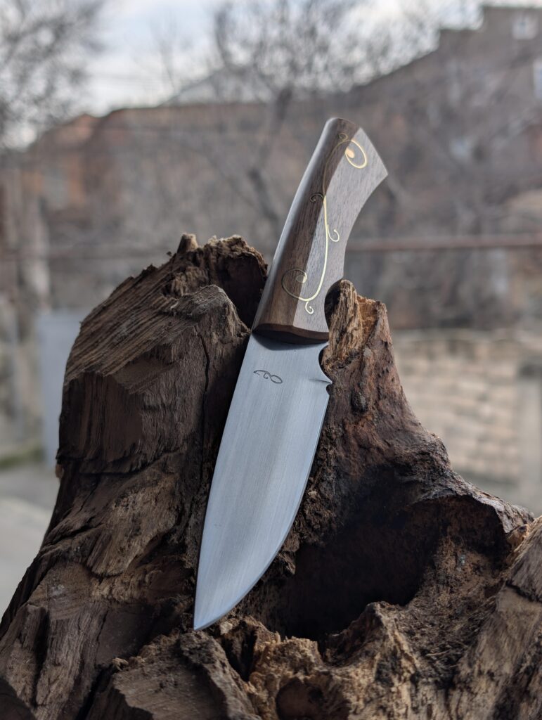 My latest one. Made of 9KhF, Soviet chromium-vanadium high carbon steel, Handle of Walnut with brass inlay and pins. 58-59 HRC. DM me if interested