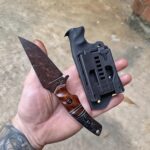 1084 with Apocalyptic finish handles Redwood lace burl and carbon fiber with natural Burlap Micarta split.