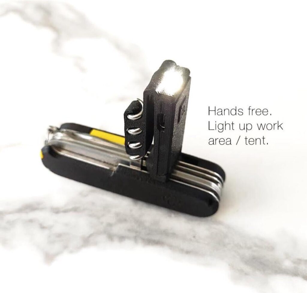 Modified Nitecore Tube flashlight that attaches to the corkscrew on a Swiss Army Knife and doubles as a pocket / belt clip