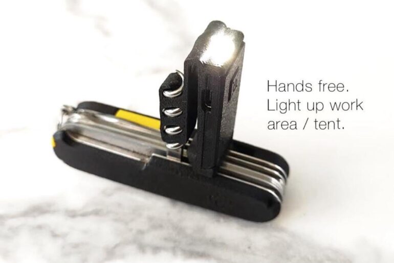 Modified Nitecore Tube flashlight that attaches to the corkscrew on a Swiss Army Knife and doubles as a pocket / belt clip