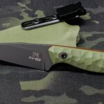 CPM 4V wharncliffe, one of my favourite smaller designs. Black Cerakote, OD G10, orange liners