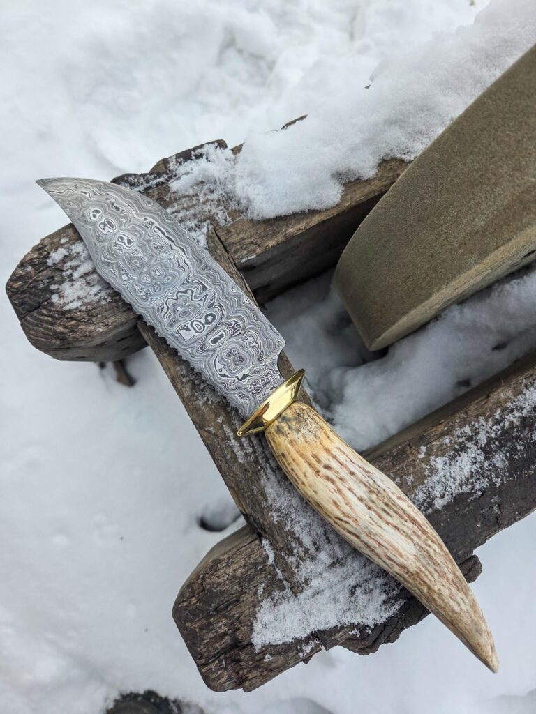 400 layers with brass and moose antler. I like big bowies and i cannot lie.