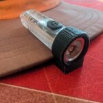 3D printed clip to use aliexpress keychain flashlight as a headlight on a ballcap