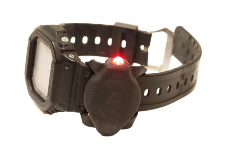 Wristwatch band mounted LED flashlight
