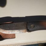 While camping last year, my knife spent the night wedged into a piece of firewood, in the fire.  Will this compromise the blade?  Anything I should do to clean it?