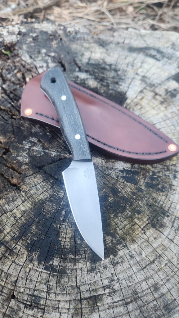 Little bog oak edc in just finished up Nitro-v , stabilized bog oak, 303 stainless pins and a handstiched 8 oz leather sheath