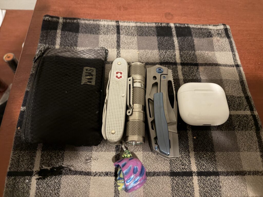 Farmer x alox chums wallet lumintop light prince customs protean and some AirPod 4 because I’m to broke for the pros, not pictured iPhone 17