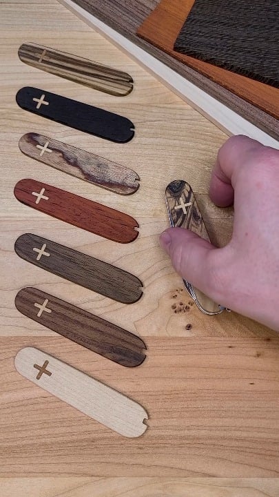 Olive wood with maple inlays Plus scales on the Victorinox Spartan.