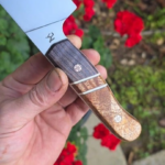 7 inch AEB-L Chef fly around. Old Growth dyed Red Wood and Quilted Maple. Ivory G10 liners.