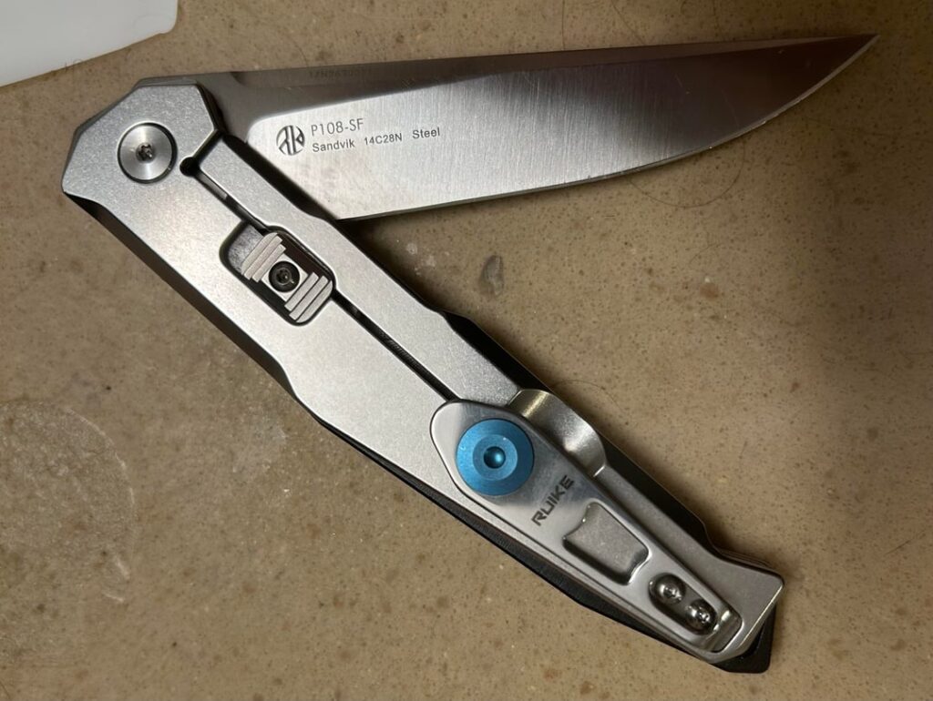 Favorite silver color-titanium/stainless scaled flipper knife? Pics? Looking for a few extra besides these I got. JW not a fan of the Pyrite or Leek. Love my P108 (smooth flip) but want higher end blade steel.