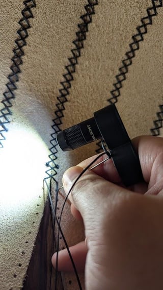 While working on a big leather project, I realized my headlamp wasn't illuminating the inside very well. I needed a hands-free flashlight that lit around my hands. So I designed and printed one: Introducing the iMini2 Ring.
