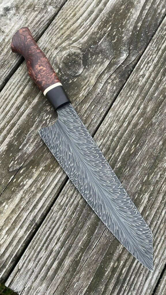 Here's a new knife, our feather Damascus with Honduran Rosewood Burl. She's a beut right?