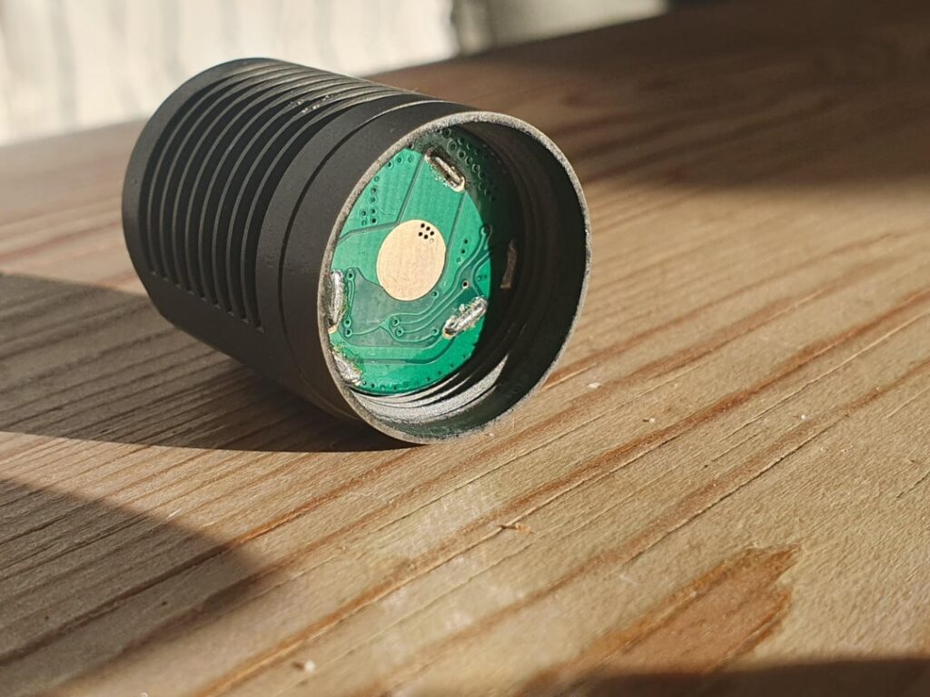 Which flashlight is this, and what's the deal with the battery stabilizer thingie?