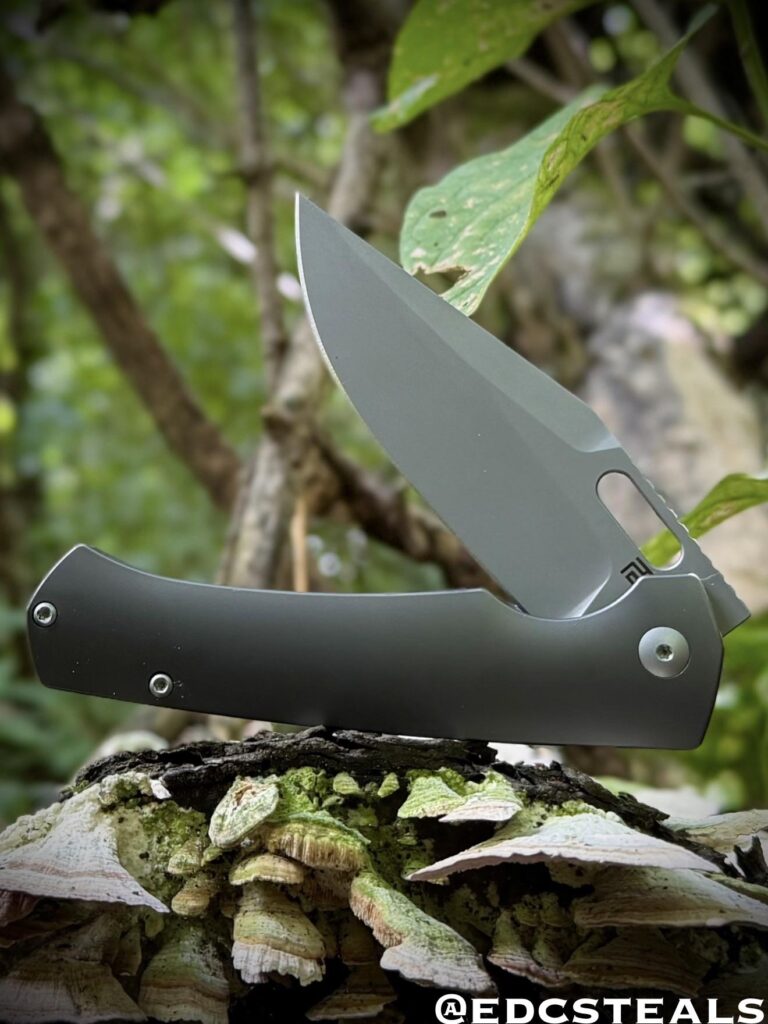 Artisan Cutlery Revel S90V/Ti. I love shape/silhouette but what really put it over the top for me is the shiny coating on the contoured handle paired with the matte grey blade