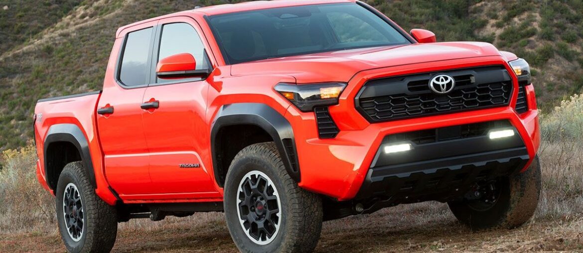 An orange 2025 Toyota Tacoma from a front quarter angle view.