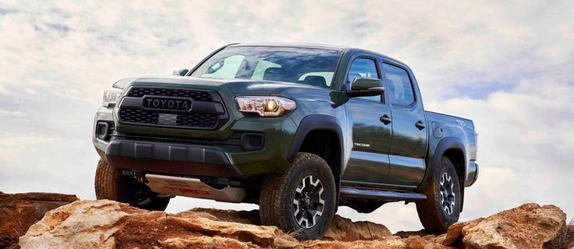 Green 2021 Toyota Tacoma TRD Off-Road positioned on rocky terrain.