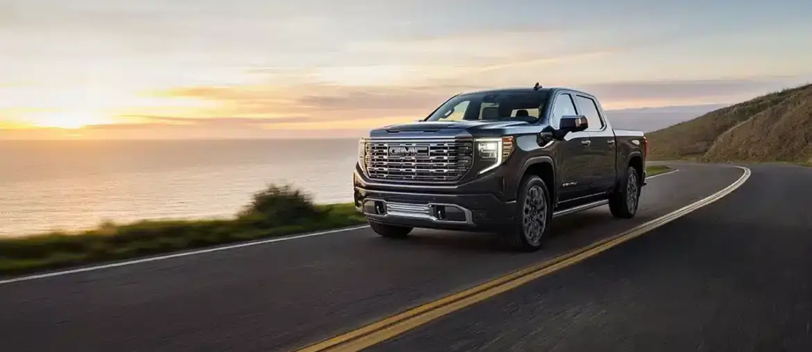 GMC Sierra Denali Ultimate on a coastal road