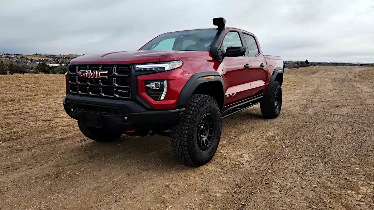 Red 2026 GMC Canyon AT4X parked on gravel